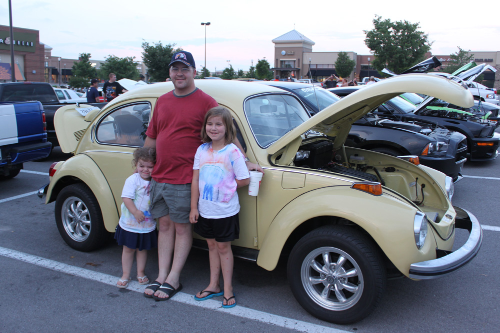 VW Family beside their Super beetle