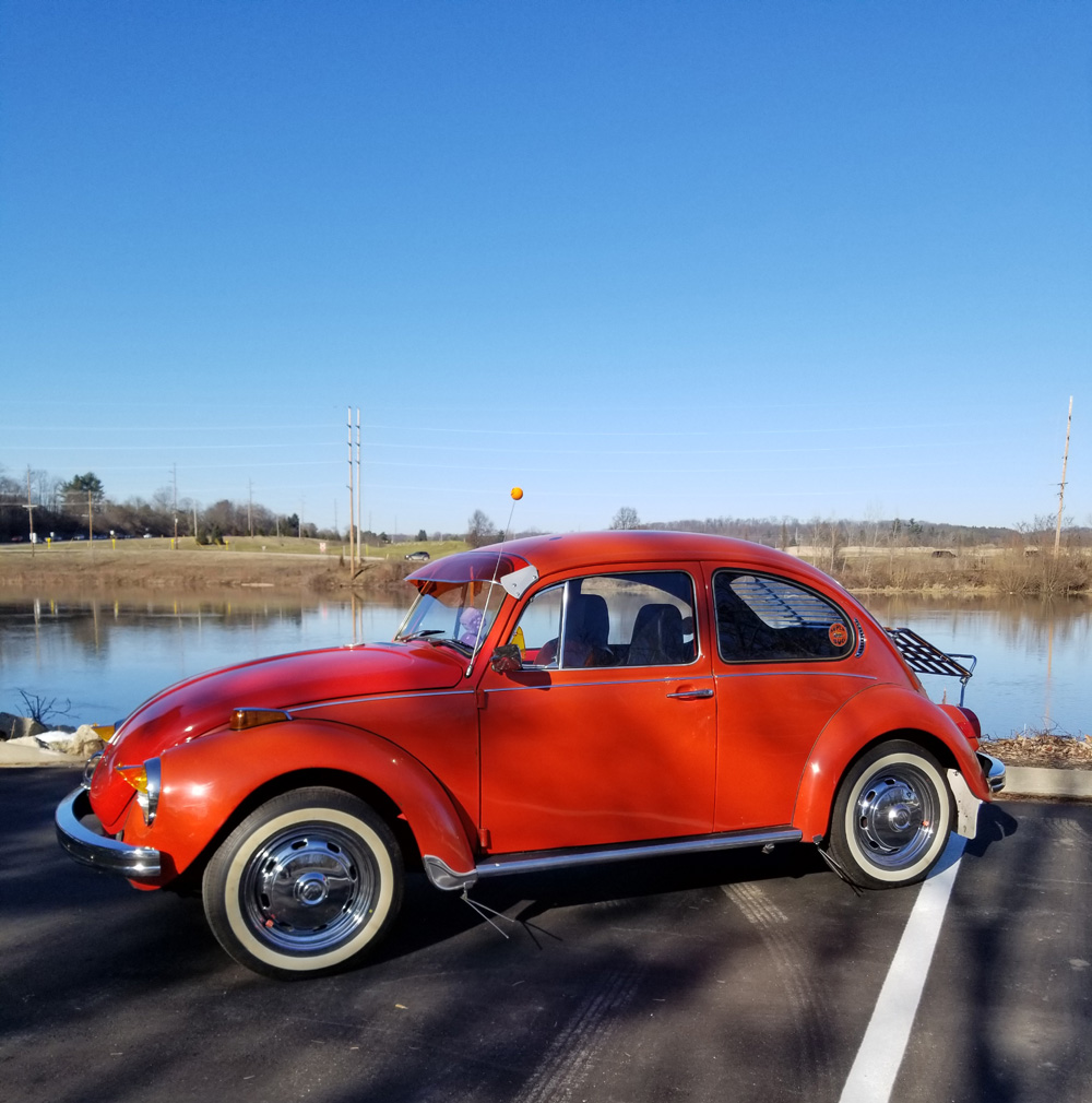 Orange Super Beetle with whitewall tires