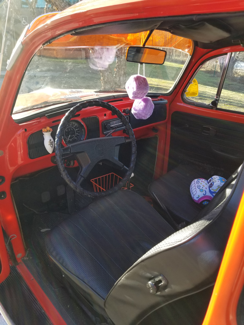 VW Super Bug with fuzzy dice on the mirror