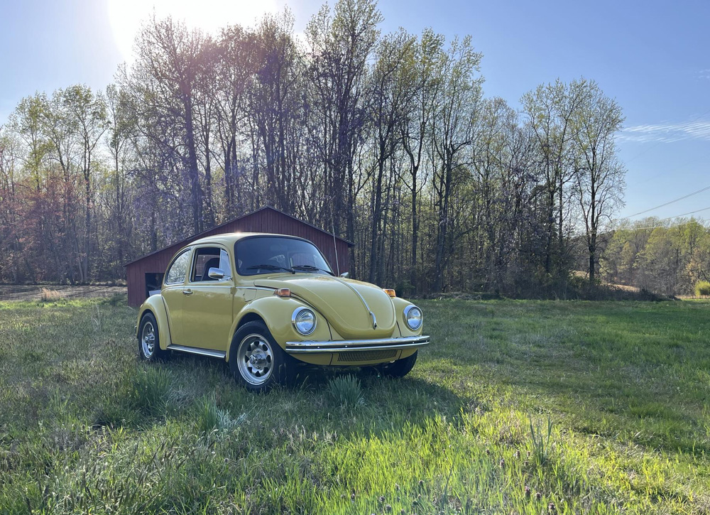 1973 Super Beetle in a field by a barn
