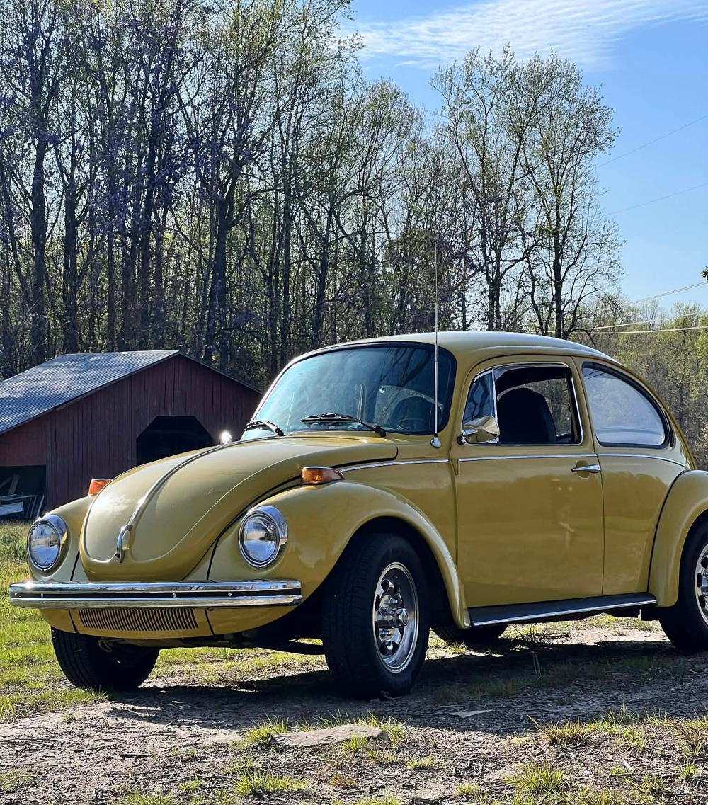 1303 Super beetle parked in a field