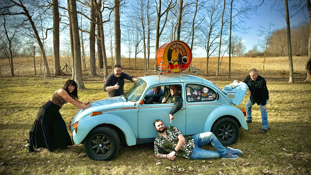 The Smoking Horses with a blue Super Beetle