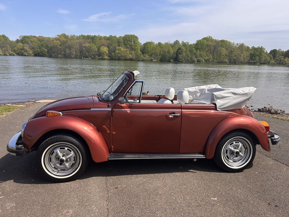 Brown 1978 Champagne Edition II Super Beetle convertible with white top in a residential neighborhood
