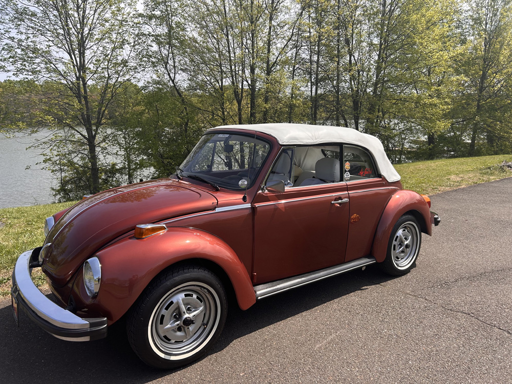1978 Champagne Edition II Super Beetle convertible parked by a field on an overcast day