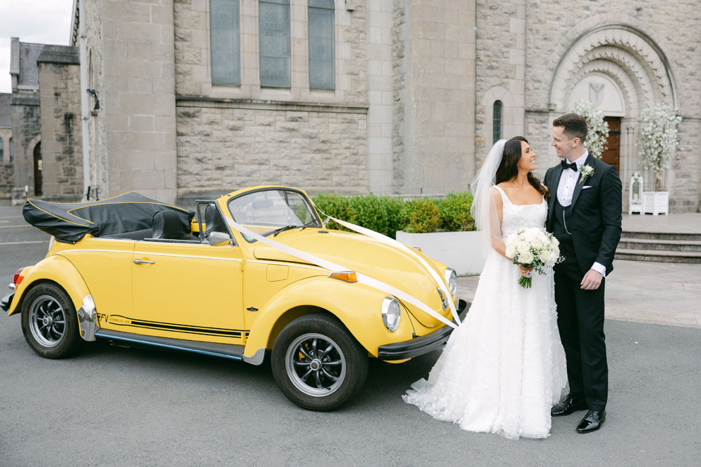 People getting married beside a 1302 Convertible