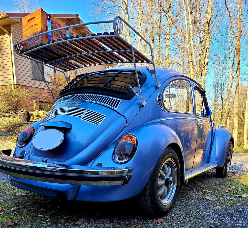 Blue VW Beetle with roof rack and rear window louver