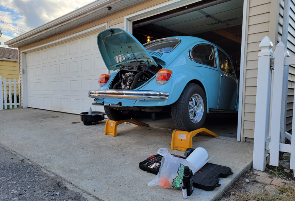 Classic Volkswagen Super Beetle raised on jack stands for a spring oil change and engine inspection.