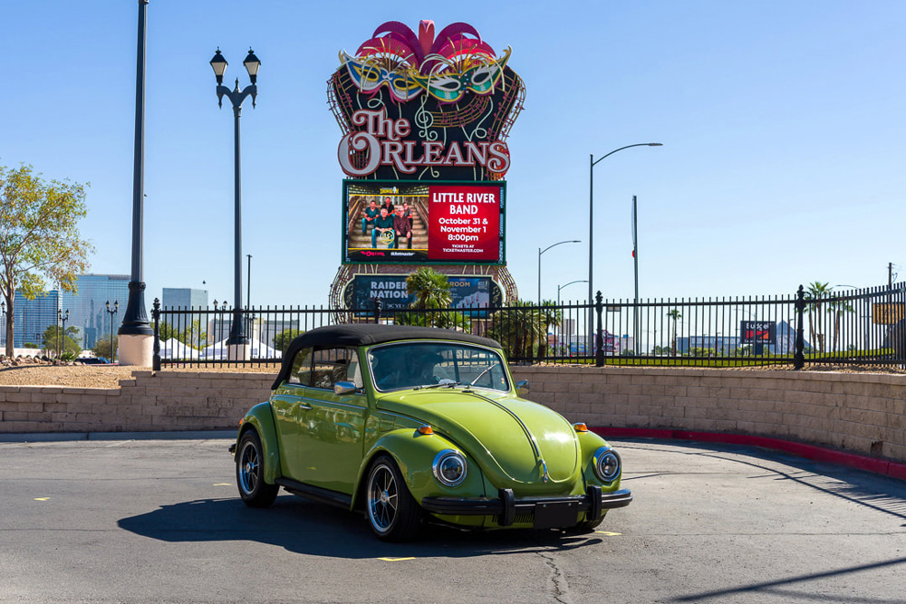 1302 Super Beetle parked by the Las Vegas sign