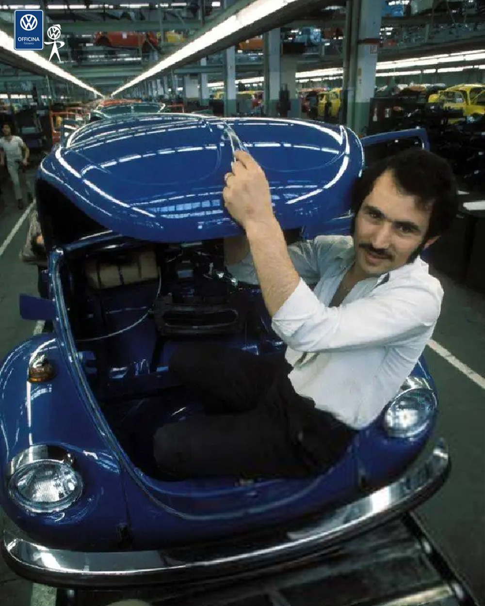line worker in the trunk of a 1972 Super Beetle